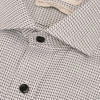 Close up of dress shirt with black chevron pattern and black buttons