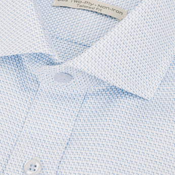 Close up of semi-spread collar on a dress shirt with a blue chevron pattern